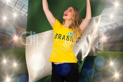 Excited football fan in brasil tshirt holding nigeria flag