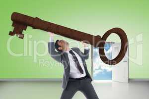 Composite image of unsmiling businessman lifting key