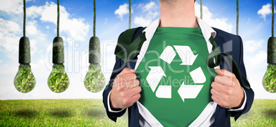 Composite image of businessman opening shirt in superhero style