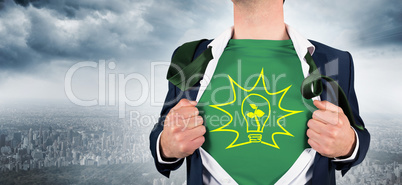 Composite image of businessman opening shirt in superhero style