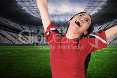 Excited asian football fan cheering