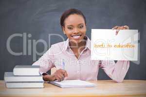 Happy teacher holding page showing back to education