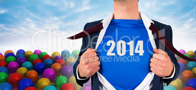 Composite image of businessman opening his shirt superhero style