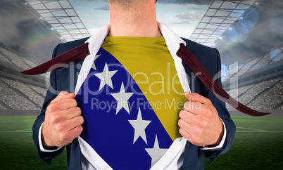 Businessman opening shirt to reveal bosnia flag