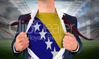 Businessman opening shirt to reveal bosnia flag