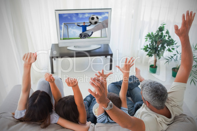 Family cheering and watching the world cup at home