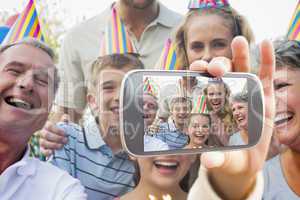 Composite image of hand holding smartphone showing