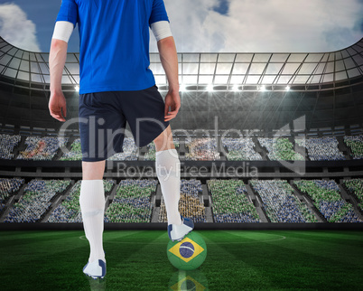 Football player standing with brasil ball