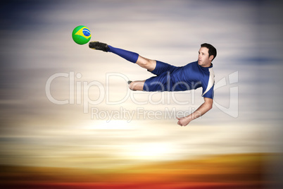 Football player in blue kicking