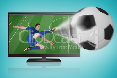 Football player in blue kicking ball out of tv