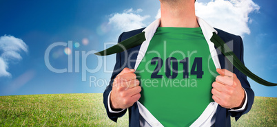 Composite image of businessman opening shirt in superhero style