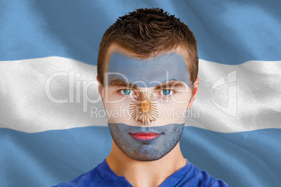 Serious young argentina fan with facepaint