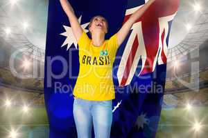 Excited football fan in brasil tshirt holding australia flag