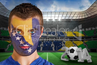 Serious young bosnia fan with face paint