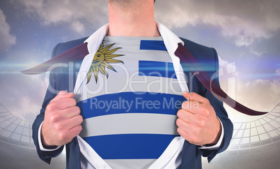 Businessman opening shirt to reveal uruguay flag