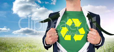 Composite image of businessman opening shirt in superhero style