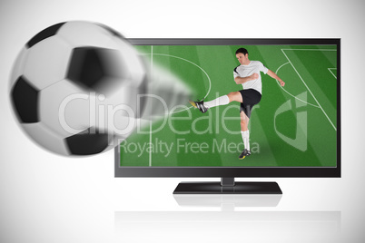 Football player in white kicking ball out of tv