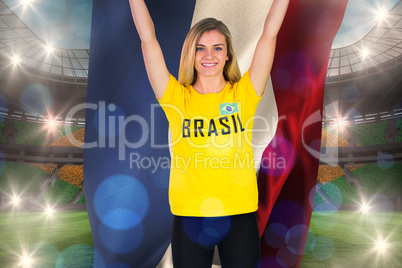 Excited football fan in brasil tshirt holding netherlands flag