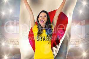 Excited football fan in brasil tshirt holding japan flag