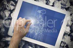 Composite image of hand touching tablet