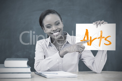 Happy teacher holding page showing arts