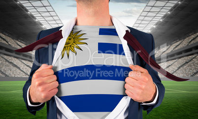 Businessman opening shirt to reveal uruguay flag