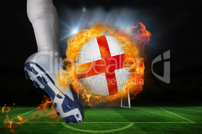 Football player kicking flaming england flag ball