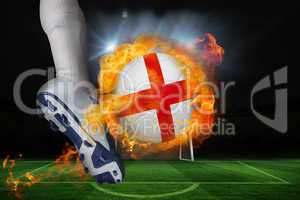Football player kicking flaming england flag ball