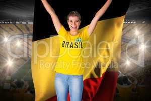 Excited football fan in brasil tshirt holding belgium flag