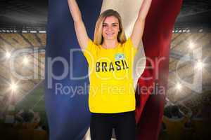 Excited football fan in brasil tshirt holding netherlands flag