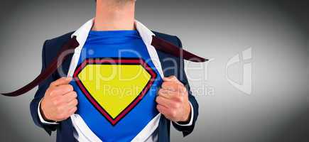 Composite image of businessman opening shirt in superhero style