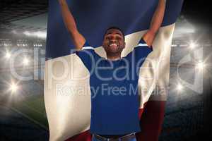 Cheering football fan in blue jersey holding france flag