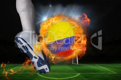 Football player kicking flaming colombia flag ball
