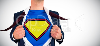Composite image of businessman opening shirt in superhero style