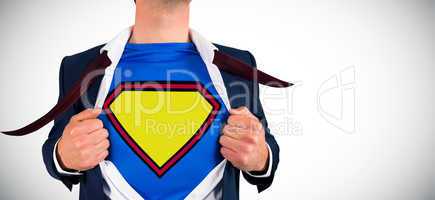 Composite image of businessman opening shirt in superhero style