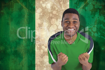 Cheering football fan in green jersey