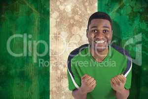 Cheering football fan in green jersey