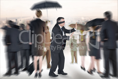 Composite image of mature businessman in a blindfold