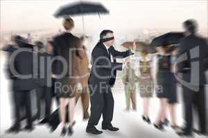 Composite image of mature businessman in a blindfold