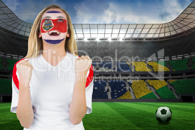 Excited costa rica fan in face paint cheering