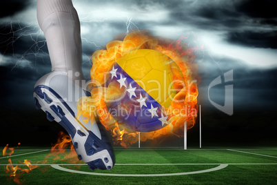 Football player kicking flaming bosnia flag ball