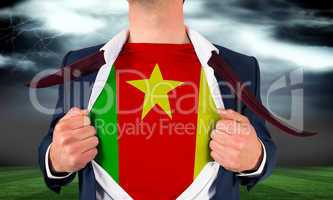 Businessman opening shirt to reveal cameroon flag