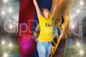 Excited football fan in brasil tshirt holding ecudaor flag
