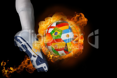 Football player kicking flaming international flag ball