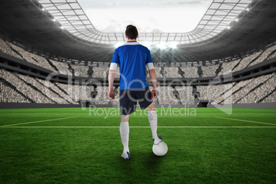 Handsome football player in blue jersey