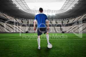 Handsome football player in blue jersey