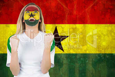 Excited ghana fan in face paint cheering