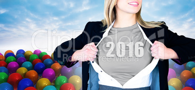 Composite image of businesswoman opening shirt in superhero styl