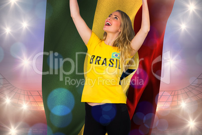 Excited football fan in brasil tshirt holding ghana flag