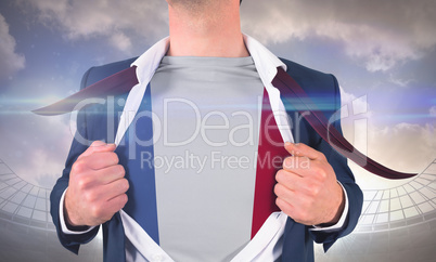 Businessman opening shirt to reveal france flag